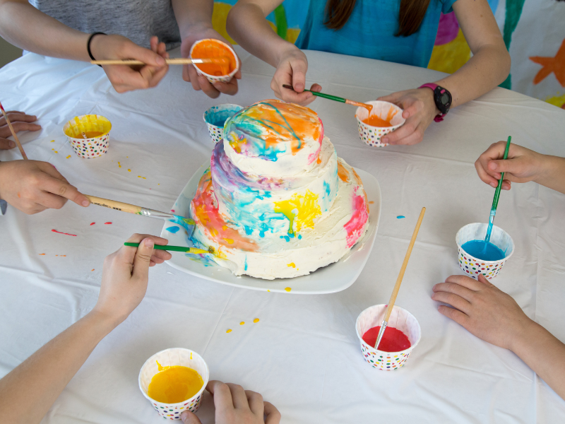 kids painting a cake