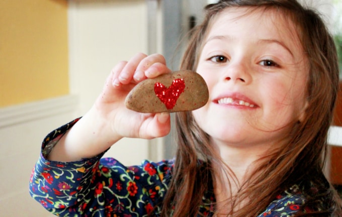 Glitter Rock Valentine Art Project -- A Great Valentine's Day Craft Project for Kids! child with glitter heart rock