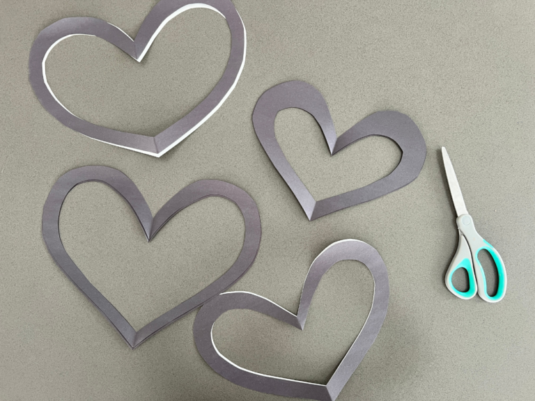 cutting hearts out of black paper