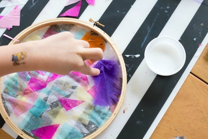 Daphne working on a tissue paper suncatcher