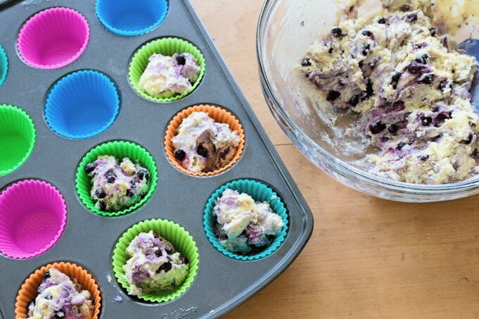 adding batter to muffin tin