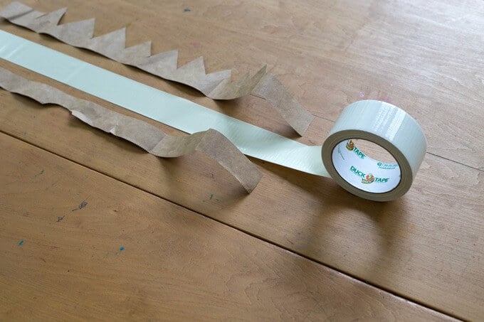 Adding duct tape to paper grocery bag crowns.