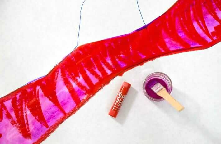 Adding liquid watercolor paint over paint stick paint