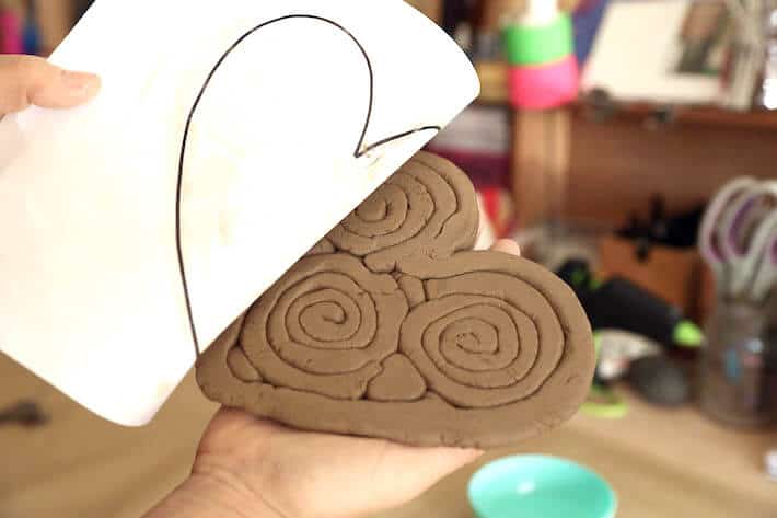Peeling paper template off of Clay Coil Heart