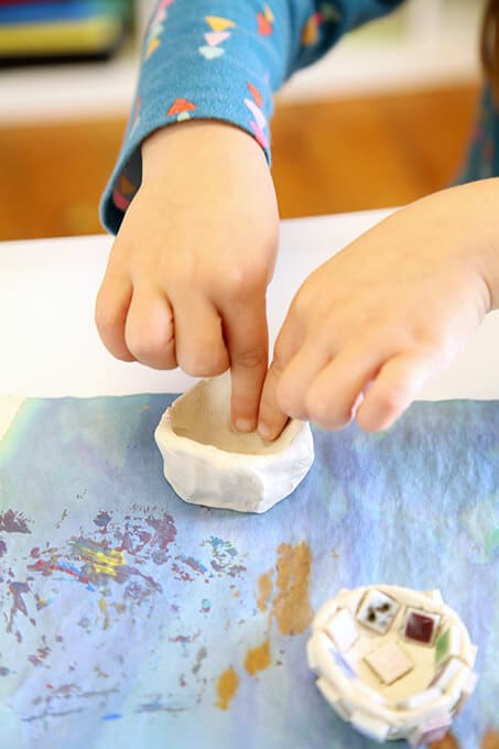 Child creating an air dry clay bowl for mosaic art for kids