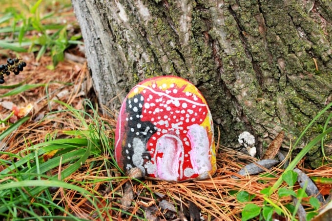 painted rock by a tree