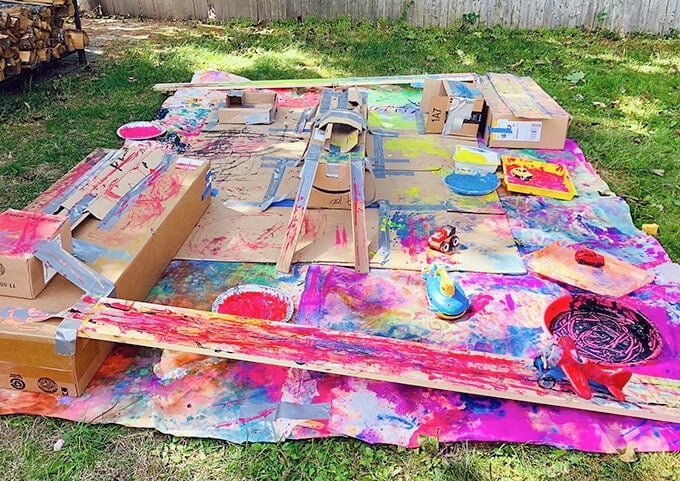 Painting with wheels cardboard and drop cloth set up