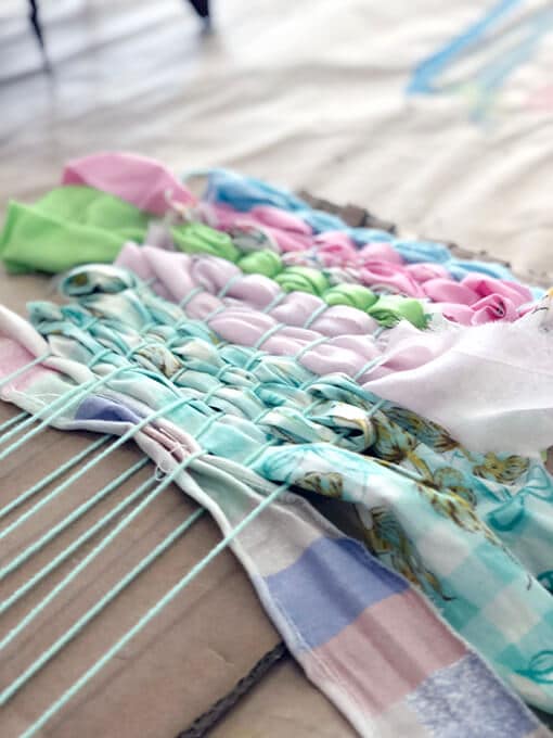 Weaving fabric and ribbon on a cardboard loom