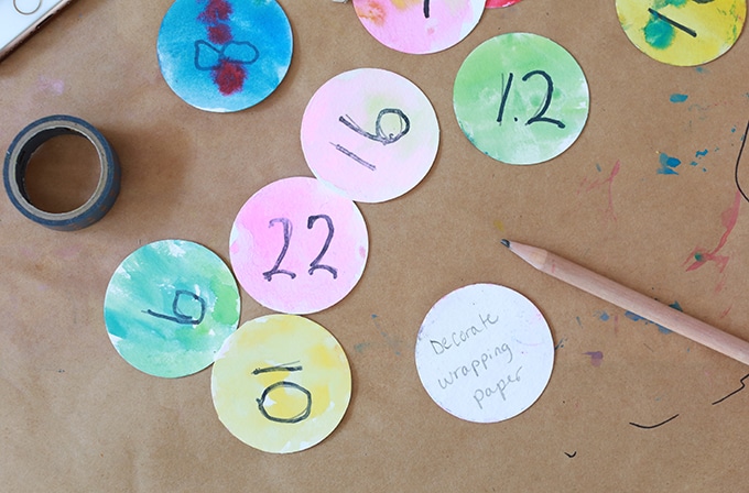 write holiday activities on paper ornaments