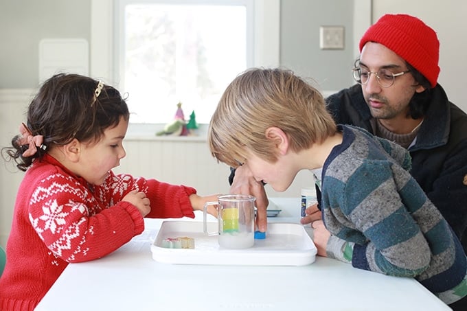 kids mixing up instant snow with water
