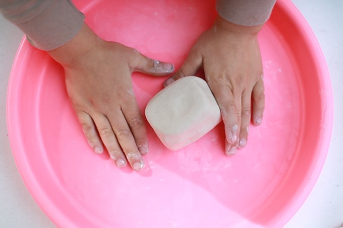 child wedging clay