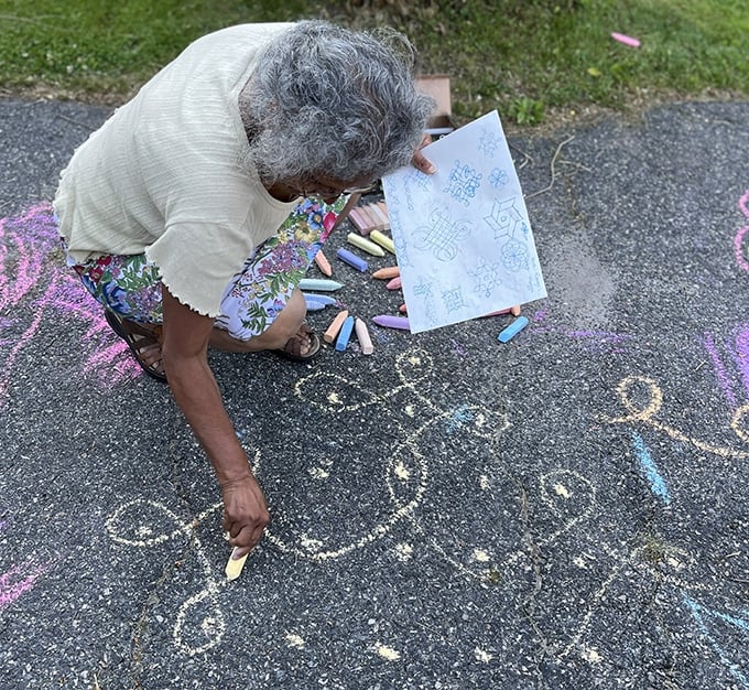 woman drawing chalk designs