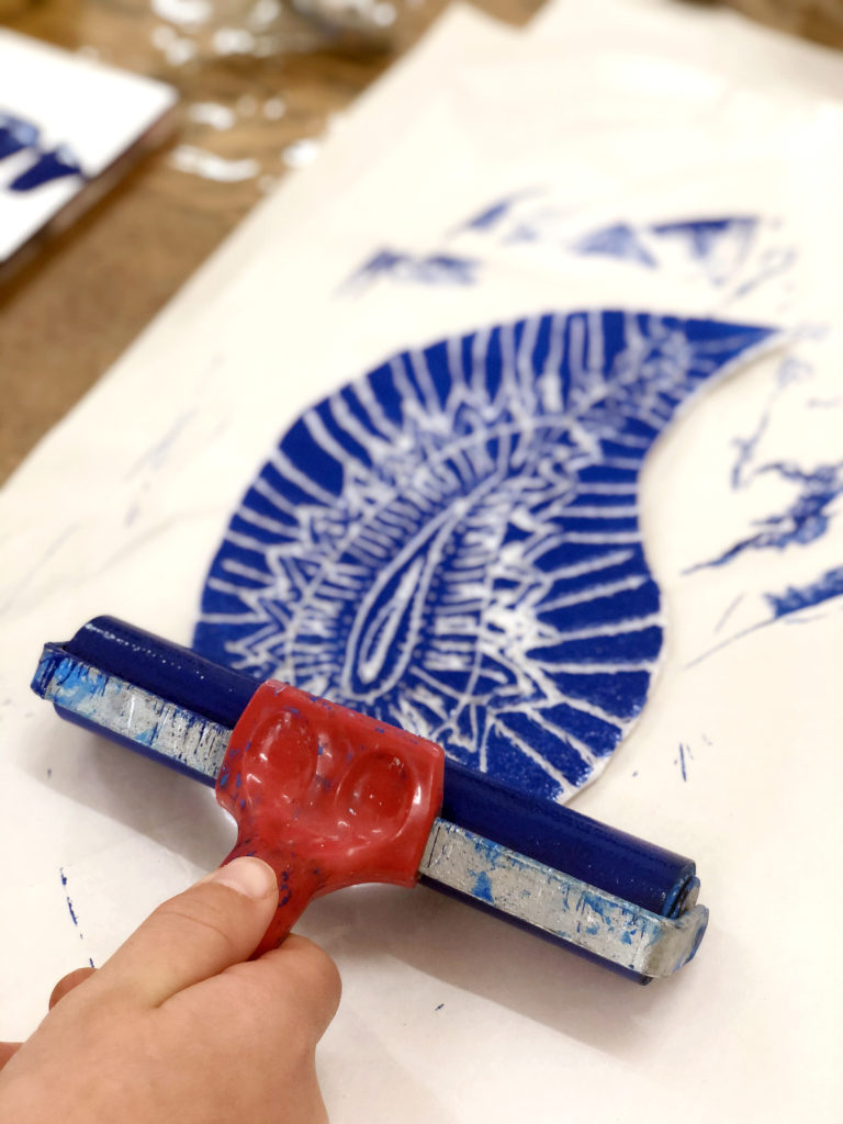 Rolling brayer on scratch foam printing plate