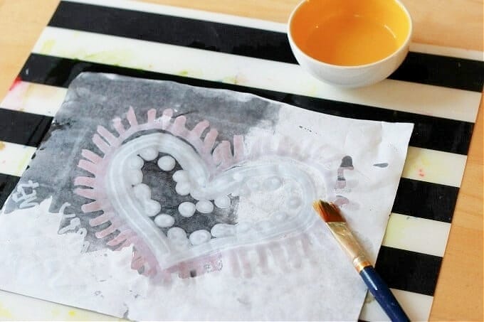 adding oil to heart painting