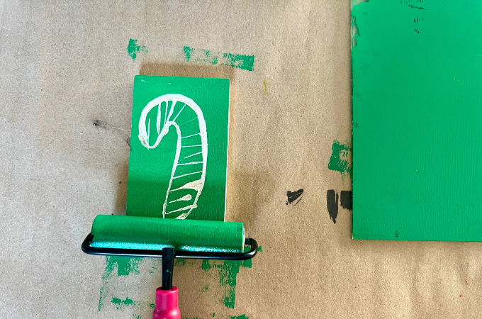 inking rubber stamp with brayer
