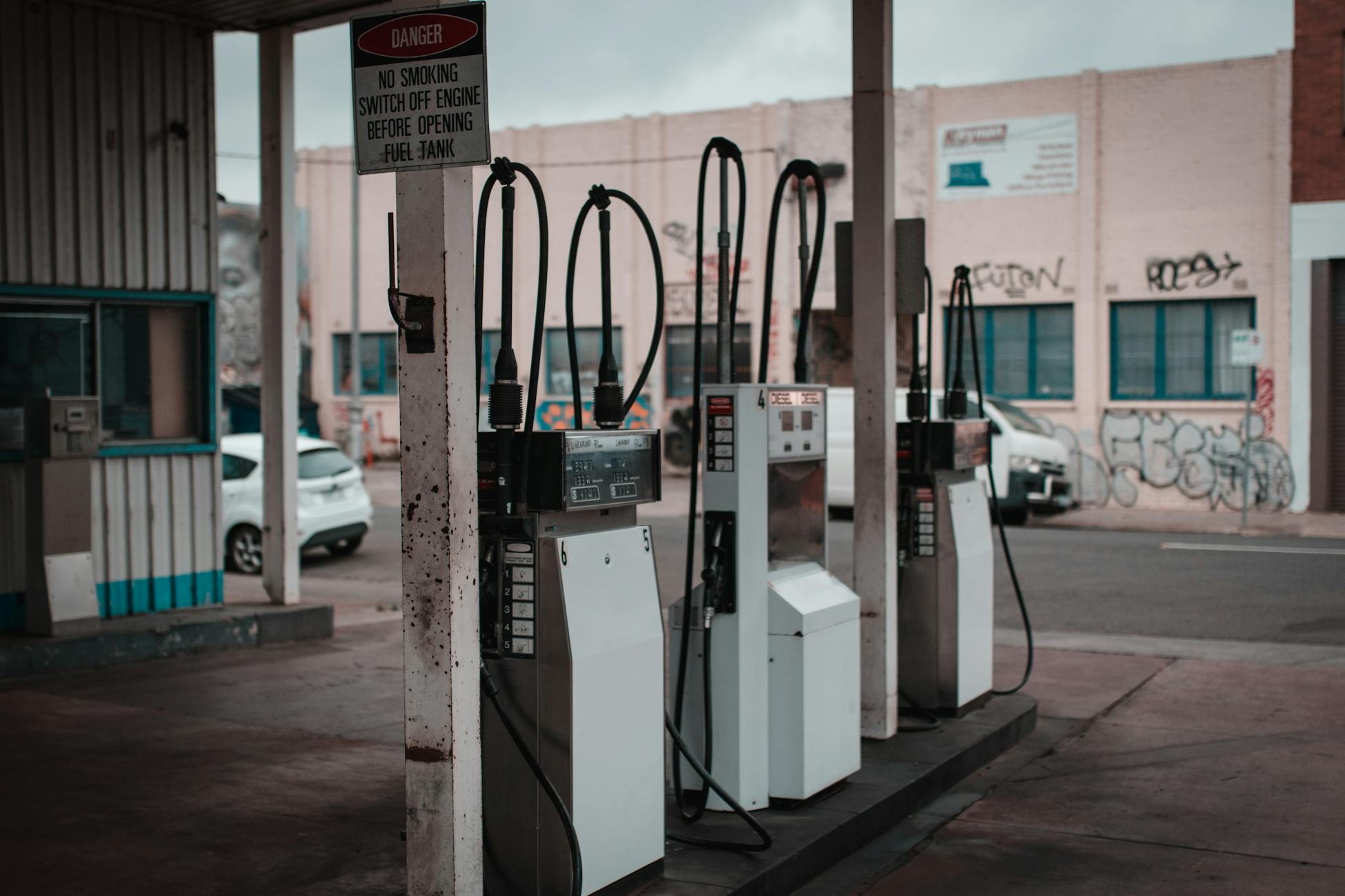 Empty gas station with visible graffiti in Collingwood, Australia.