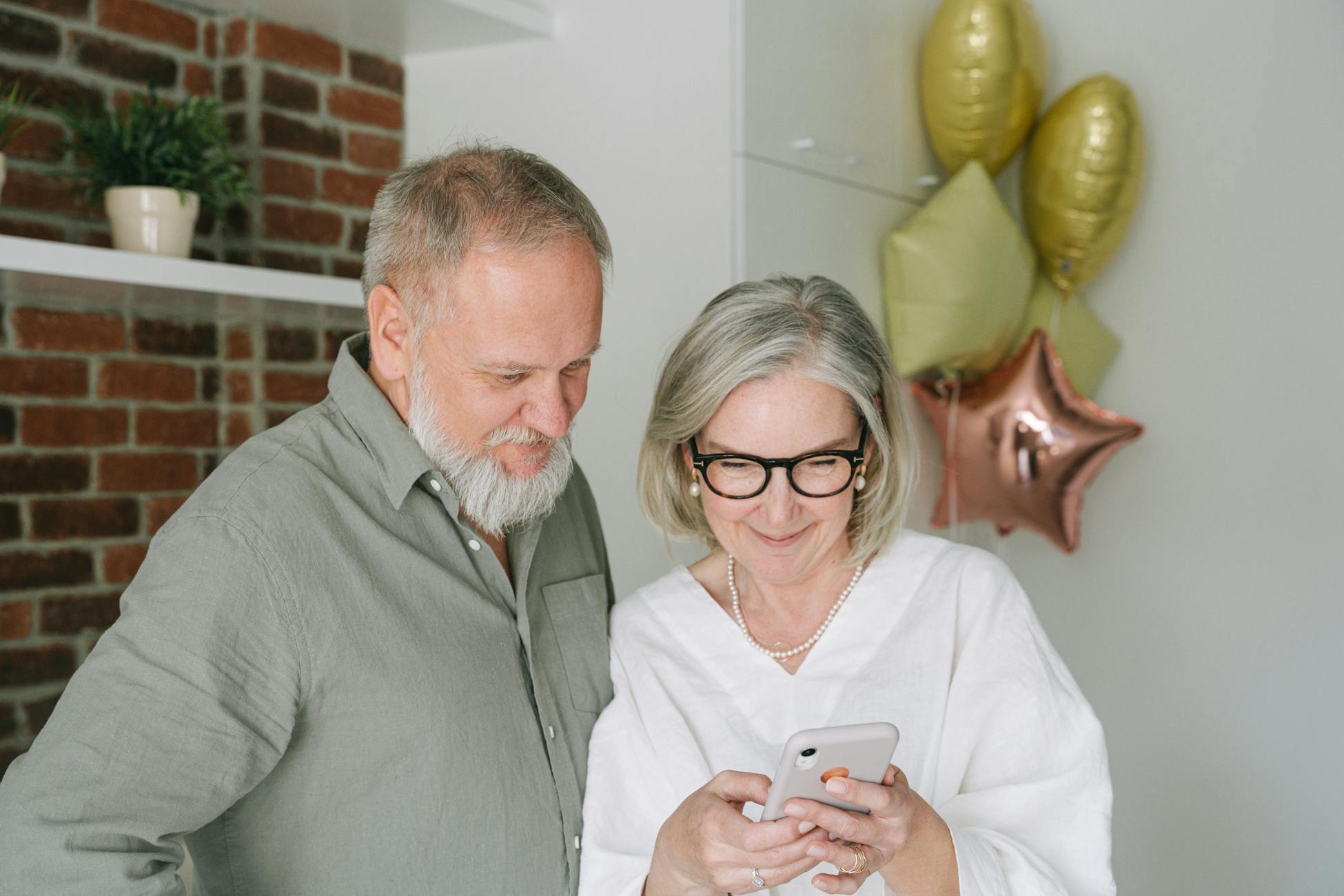 Senior couple enjoying a video call at home, sharing a warm moment together.