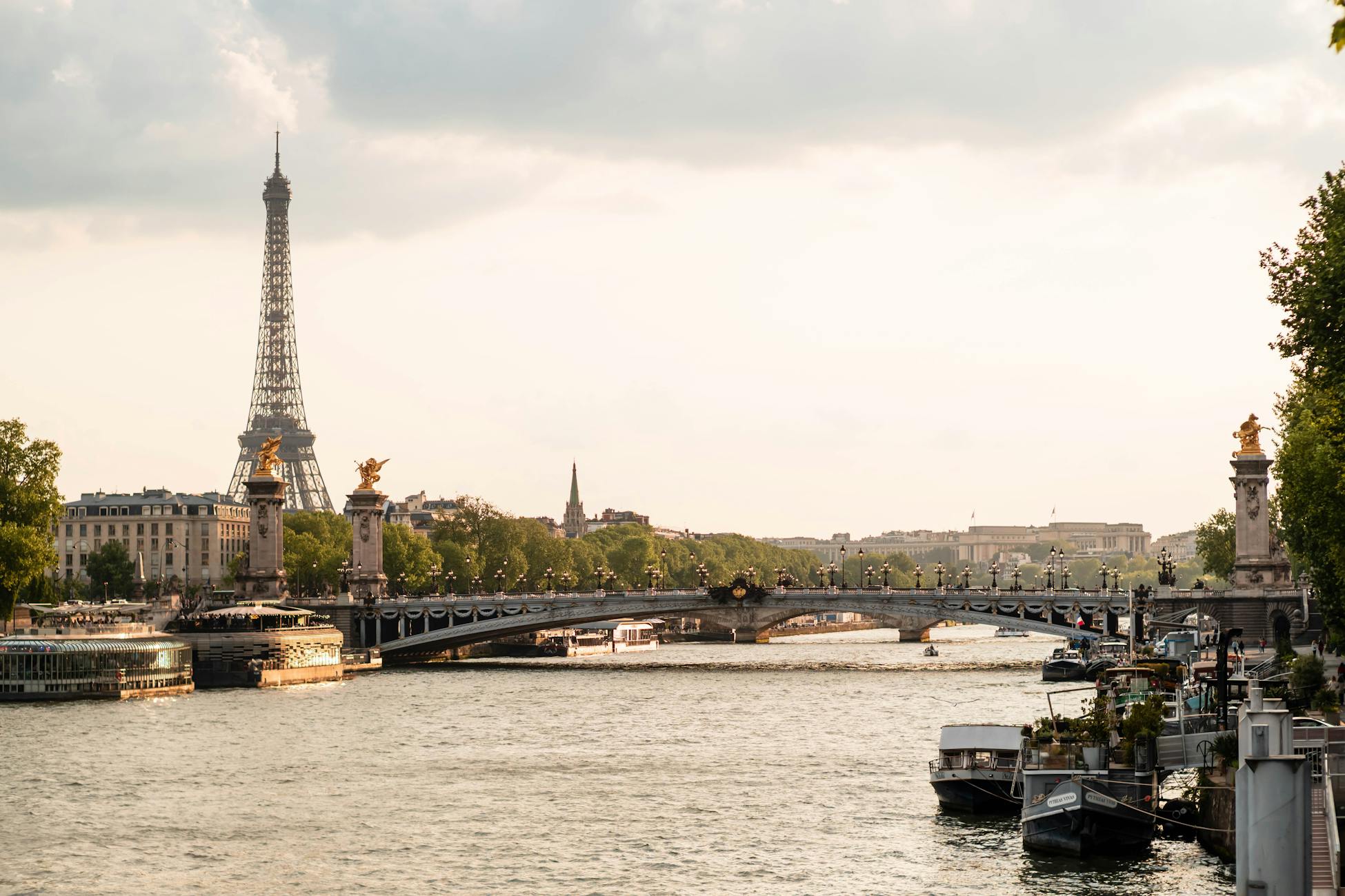 Peaceful Paris scene featuring the Eiffel Tower and a decorative bridge over the Seine River.