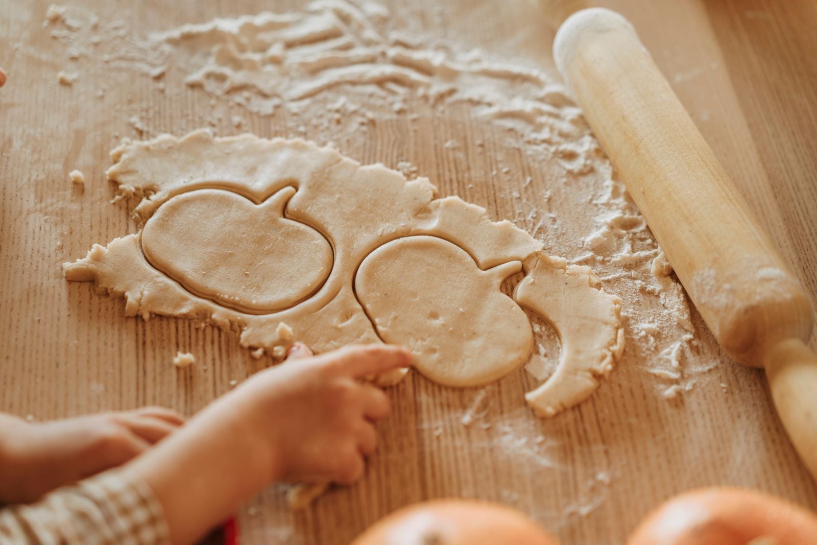 child rolling dough