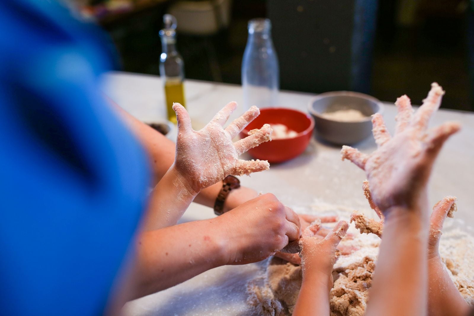 When a child pours vinegar onto a mound of baking soda in a paper-mache volcano, the acid and base swap partners in seconds and release carbon dioxide gas — the same reaction that leavens quick breads, now foaming over a kitchen tray because the bubbles have nowhere to go but up.
