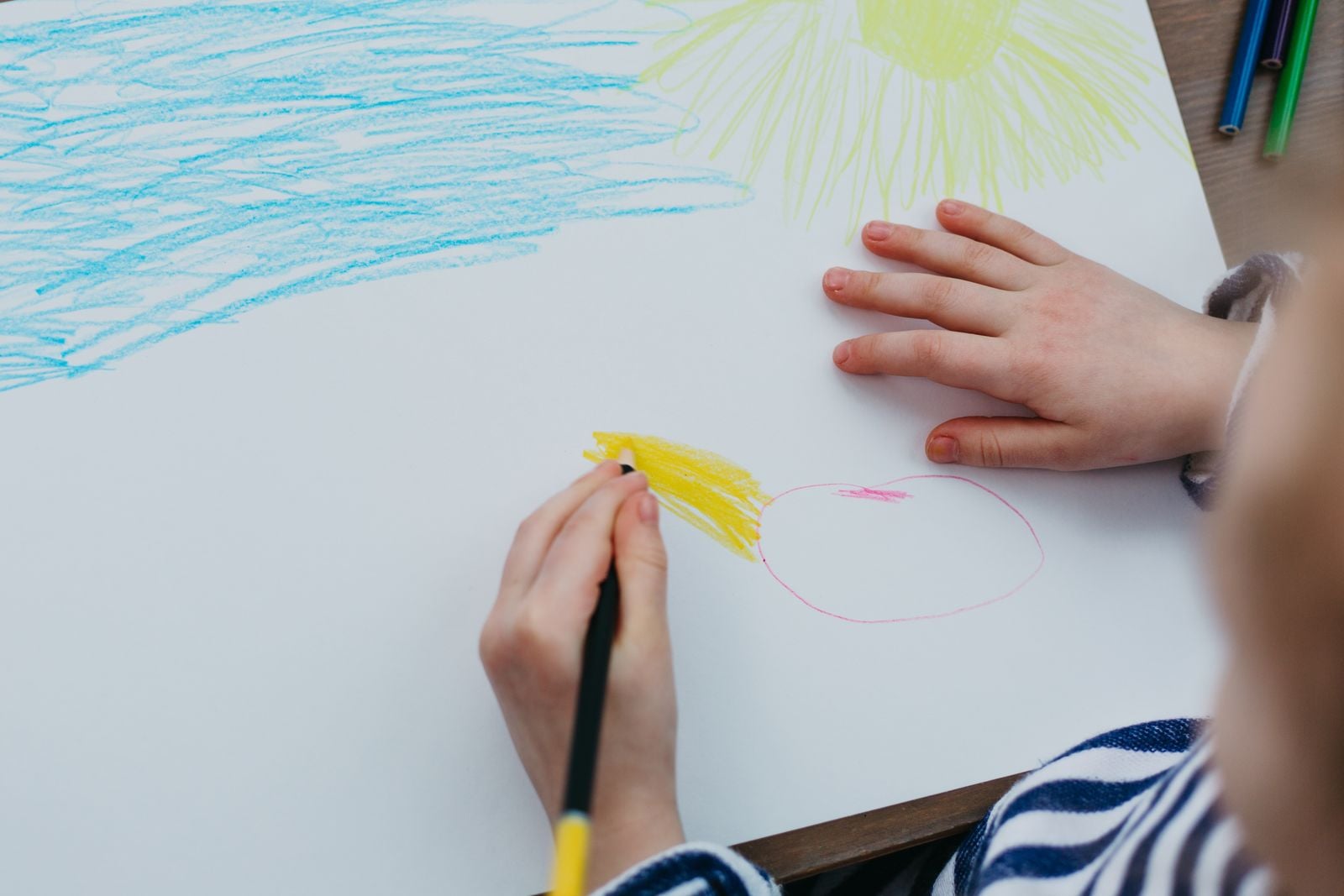 child drawing yellow sun