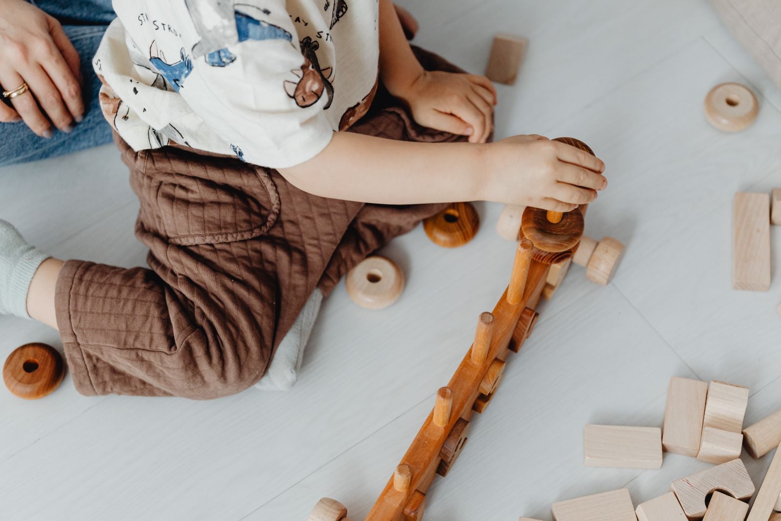 child stacking wooden blocks