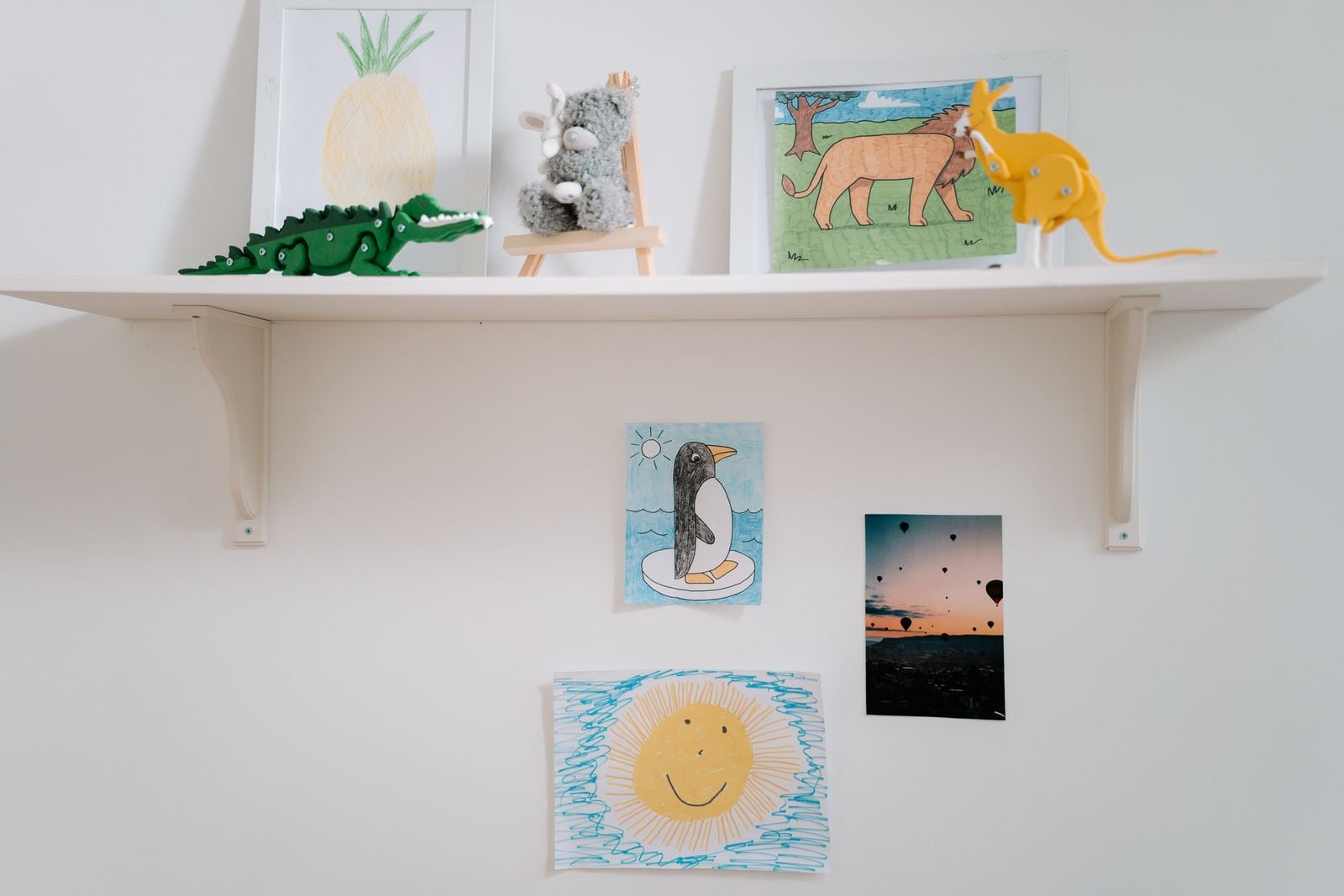 children drawings pinned wall