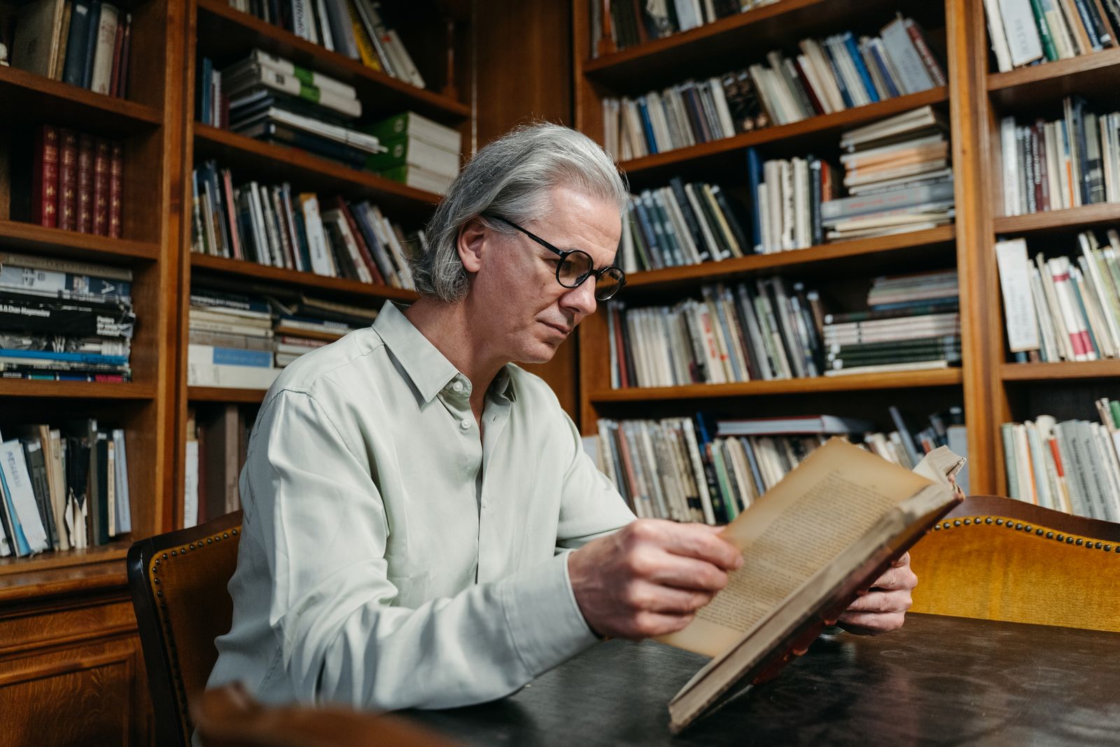 older person reading in library